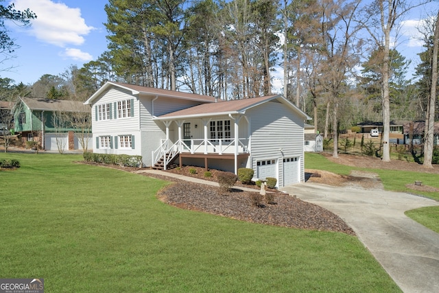 tri-level home with covered porch, concrete driveway, stairway, an attached garage, and a front lawn