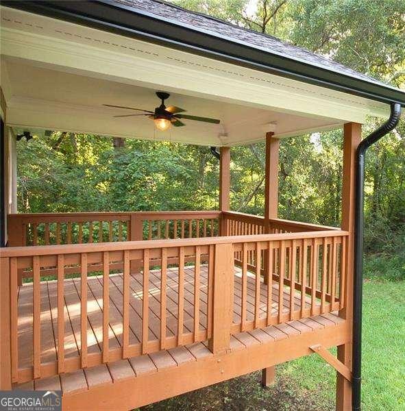 wooden deck featuring ceiling fan