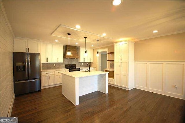 kitchen featuring black appliances, light countertops, decorative light fixtures, and white cabinets