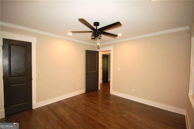 unfurnished room with ornamental molding, dark wood-type flooring, a ceiling fan, and baseboards