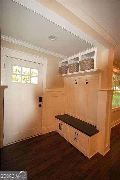 mudroom featuring dark wood-style floors and ornamental molding