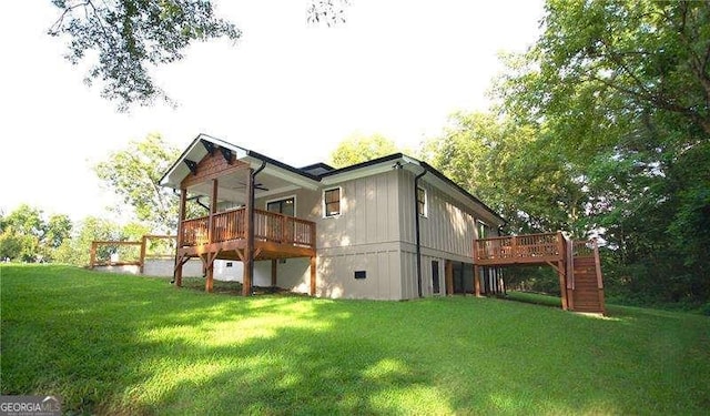 back of house with a ceiling fan, a yard, stairway, and a deck