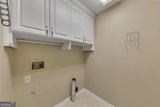 laundry area featuring washer hookup, cabinet space, and baseboards