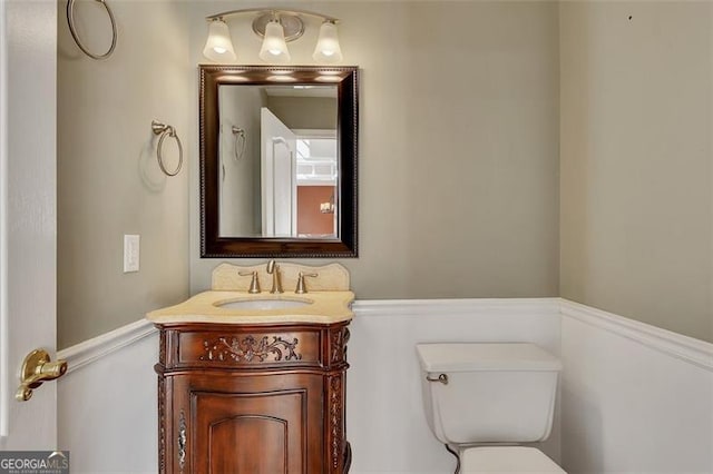 half bathroom featuring toilet and vanity