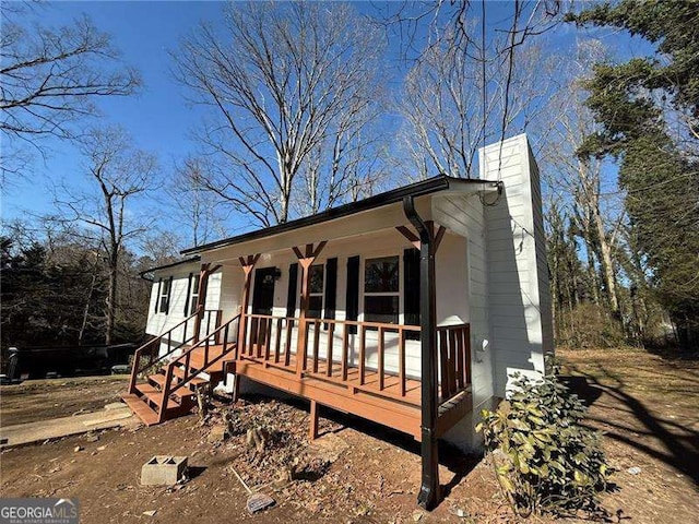 ranch-style home featuring a chimney