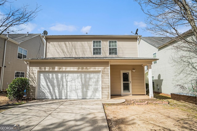 traditional-style home featuring a garage and driveway