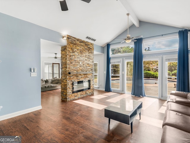 living room with a fireplace, wood finished floors, visible vents, and a healthy amount of sunlight