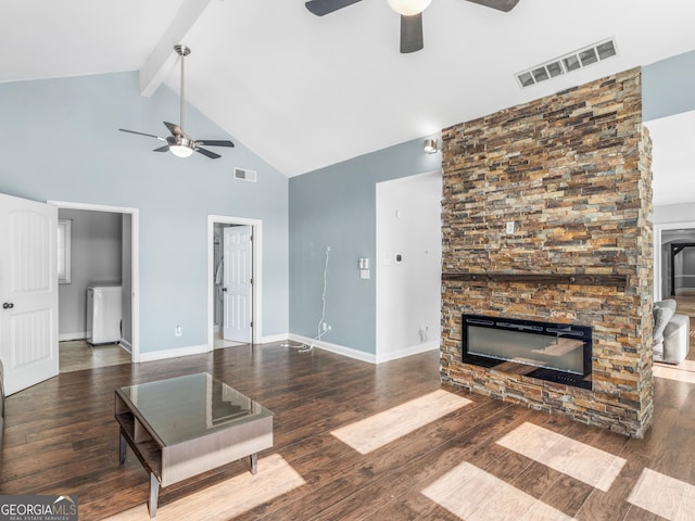 living room featuring dark wood-style floors, a fireplace, and visible vents