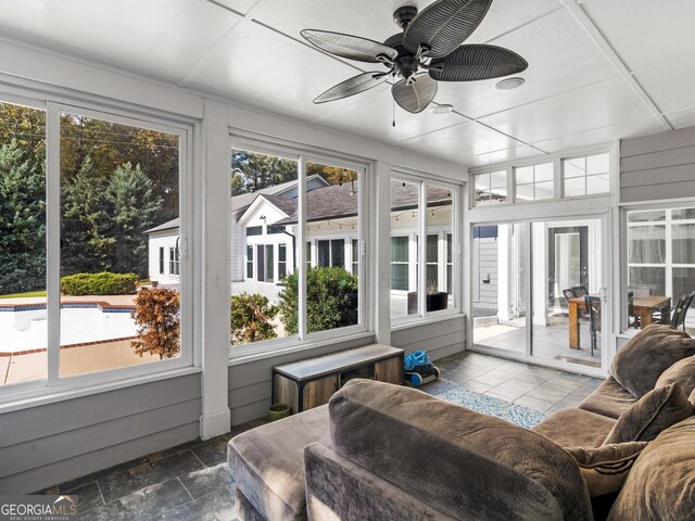 sunroom with a ceiling fan