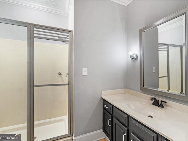 full bathroom with a stall shower, vanity, and baseboards