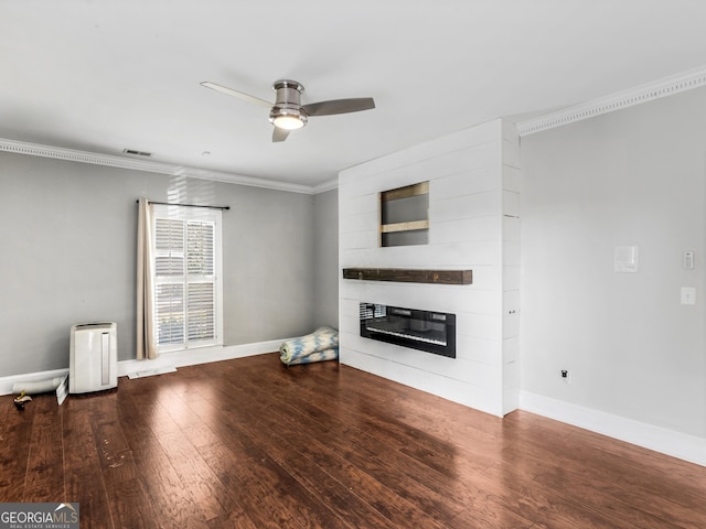 unfurnished living room featuring ceiling fan, crown molding, a fireplace, and wood finished floors