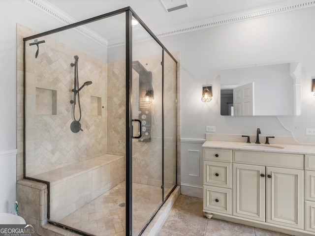 bathroom with tile patterned floors, a shower stall, and vanity