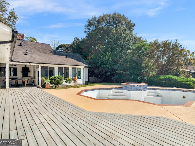 wooden terrace with a patio area and a pool with connected hot tub