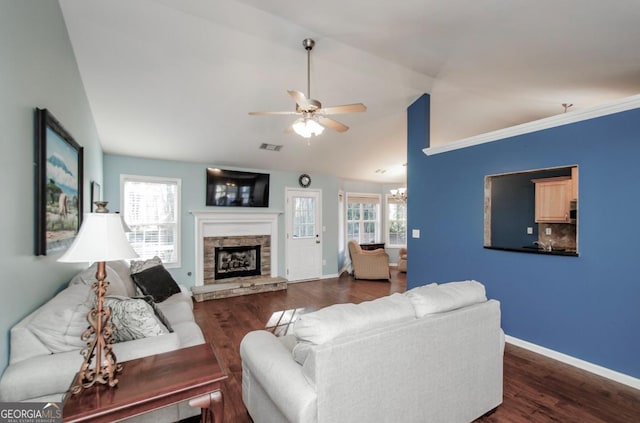 living area with lofted ceiling, dark wood-style flooring, and baseboards