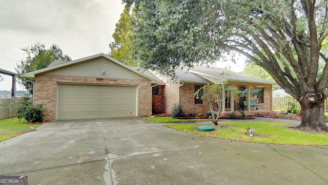 ranch-style home with driveway, brick siding, and an attached garage