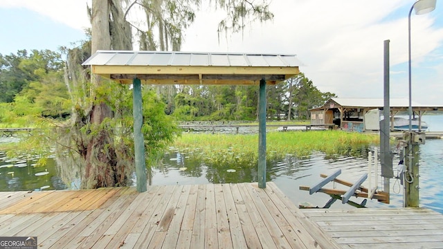 dock area with a water view and boat lift