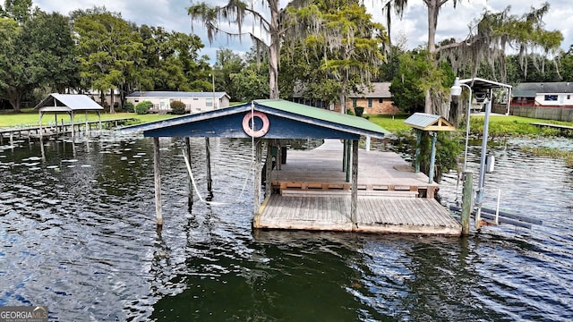 dock area with a water view and boat lift