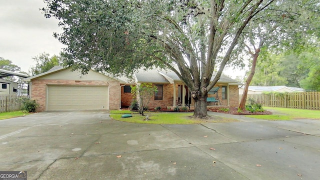 ranch-style house featuring concrete driveway, brick siding, fence, and an attached garage