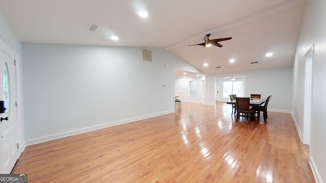 dining area featuring visible vents, light wood-style flooring, vaulted ceiling, ceiling fan, and baseboards