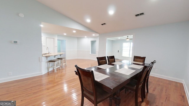 dining room with light wood-style floors, visible vents, and baseboards