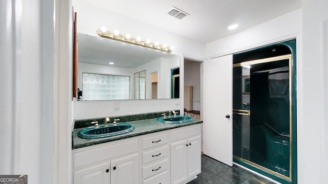 bathroom featuring double vanity, visible vents, and a sink