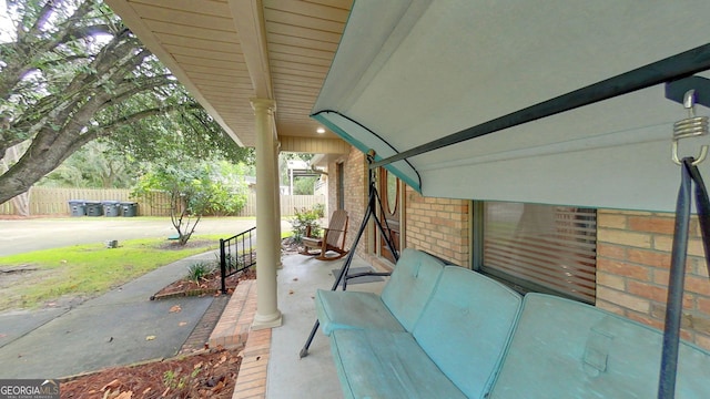 view of patio featuring fence