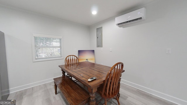 dining room with light wood-style flooring, electric panel, baseboards, and an AC wall unit