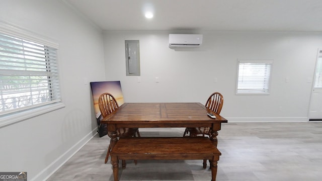 dining area featuring light wood finished floors, electric panel, baseboards, and a wall mounted AC