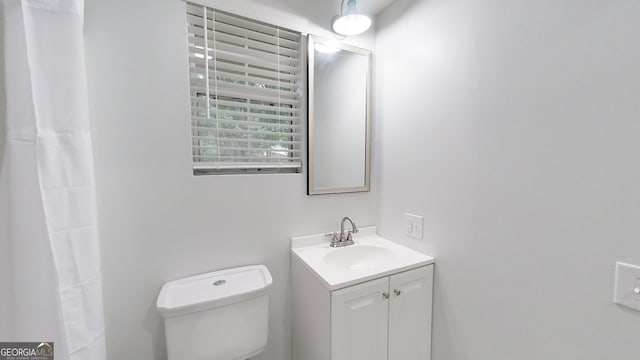 bathroom with toilet and vanity