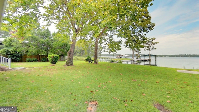 view of yard featuring a water view and fence