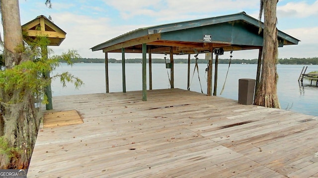 dock area with a water view and boat lift