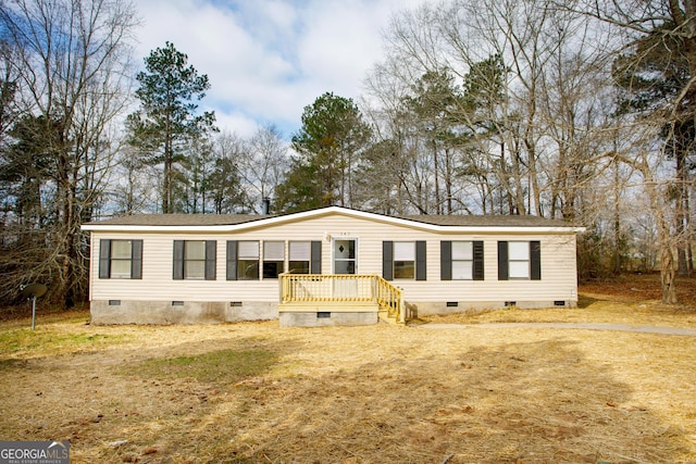 manufactured / mobile home with crawl space and a front lawn