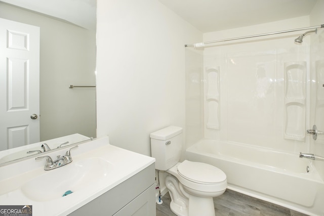 bathroom with tub / shower combination, vanity, toilet, and wood finished floors