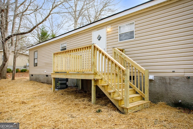 entrance to property with crawl space and a wooden deck