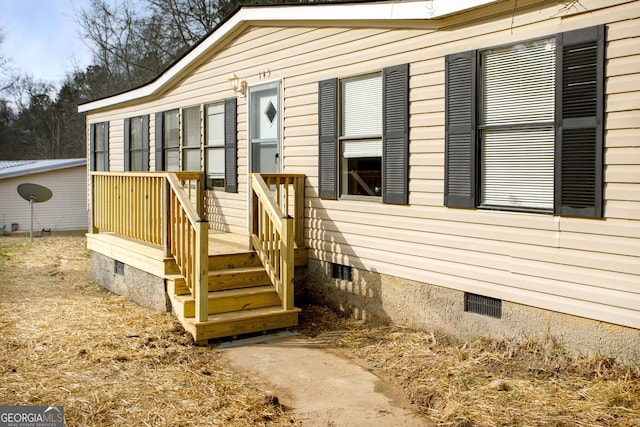 view of exterior entry featuring crawl space