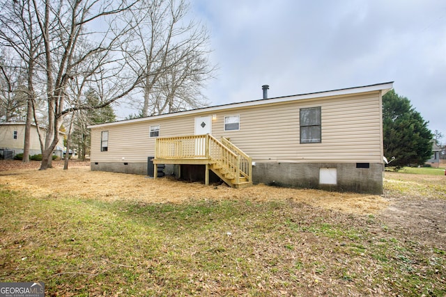 back of property featuring a wooden deck, crawl space, stairs, cooling unit, and a yard