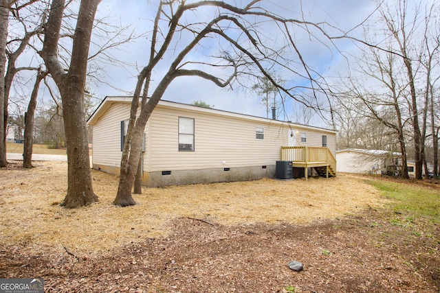 rear view of property featuring cooling unit and crawl space