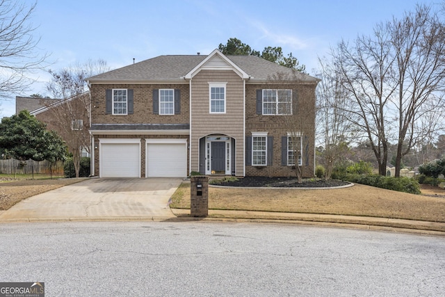 view of front of house featuring a garage, driveway, a shingled roof, and brick siding