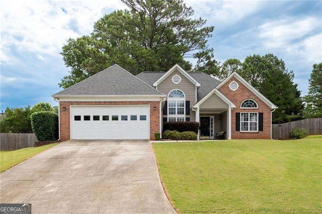 view of front of home featuring brick siding, concrete driveway, a front yard, fence, and a garage