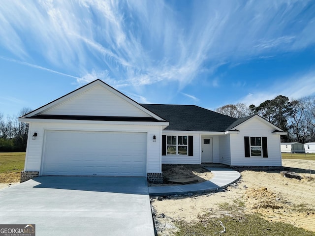 ranch-style house with a garage and concrete driveway