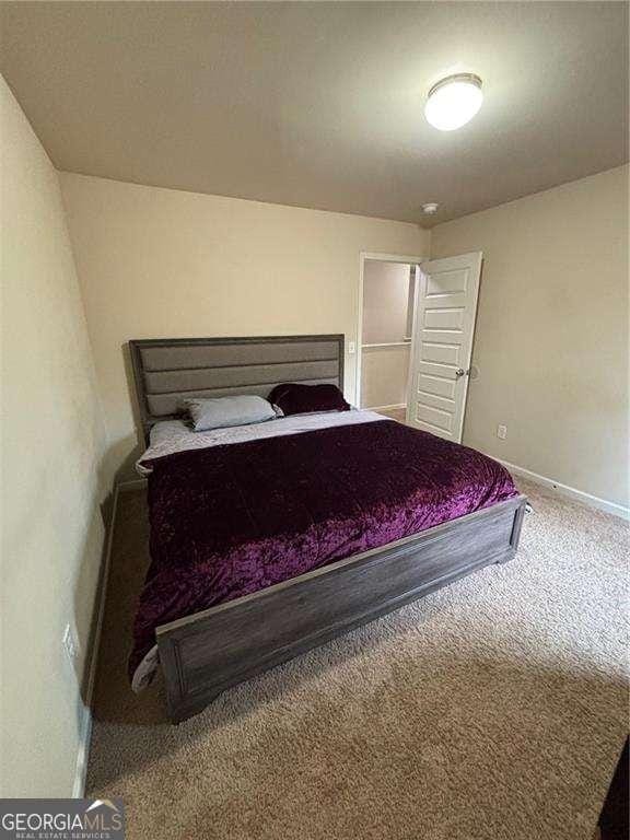 unfurnished bedroom with carpet flooring and baseboards