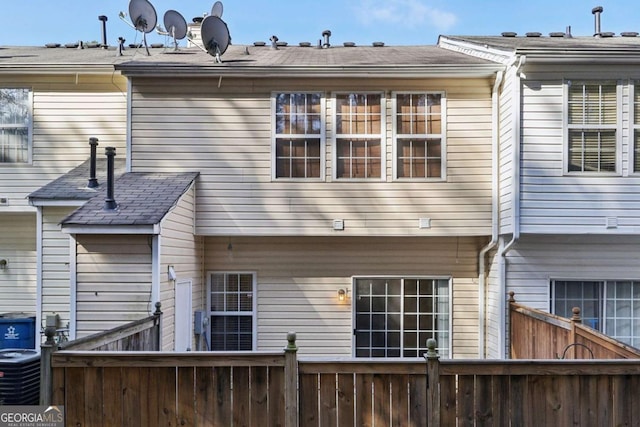 rear view of property with central AC unit