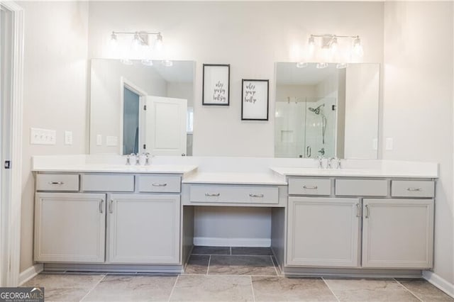 bathroom featuring a shower stall, baseboards, and vanity