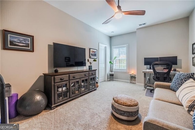 living room featuring baseboards, carpet, visible vents, and a ceiling fan