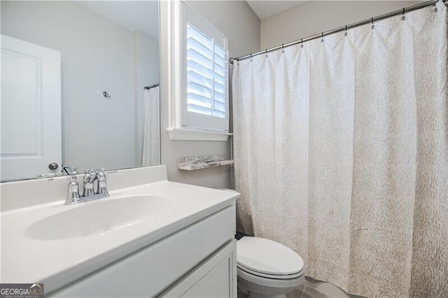 bathroom featuring vanity and toilet