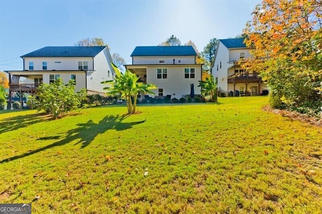 back of house with a lawn