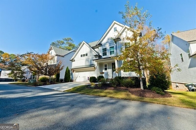 view of front of property with board and batten siding, driveway, and an attached garage