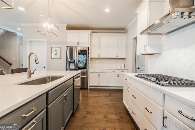 kitchen with white cabinets, appliances with stainless steel finishes, ventilation hood, and a sink