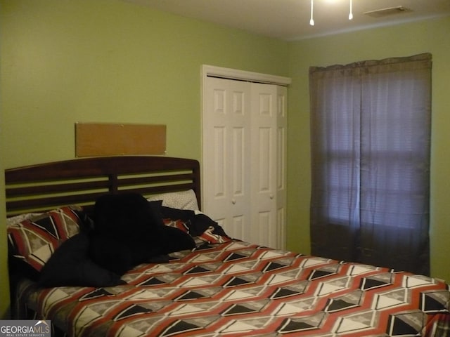 bedroom with a closet and visible vents