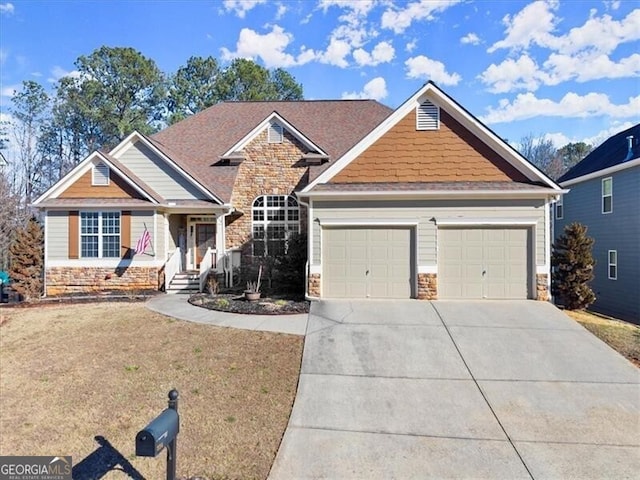 craftsman house with an attached garage, stone siding, a front lawn, and concrete driveway